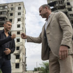 
              Former striker and coach of the Ukraine national soccer team Andriy Shevchenko, left, exchanges fist bumps with American actor Liev Schreiber in front of a house which have been destroyed by Russia bombardment in Borodianka, near Kyiv, Ukraine, on Monday, Aug. 15, 2022. (AP Photo/Evgeniy Maloletka)
            