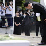 
              Japanese Prime Minister Fumio Kishida bows during a ceremony to mark the 77th anniversary of the atomic bombing in Nagasaki, southern Japan, Tuesday, Aug. 9, 2022. (Kyodo News via AP)
            