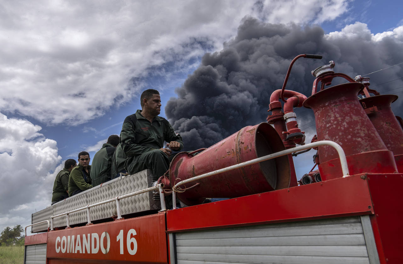 Firefighters move in a truck inside the Matanzas supertanker base to douse a fire that started duri...