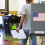 
              A voter casts their ballot at Cesar E Chavez Elementary during the Michigan Primary Election in Grand Rapids, Mich. on Tuesday, Aug. 2, 2022. (Joel Bissell/The Grand Rapids Press via AP)
            