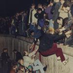 
              FILE - East Berliners get helping hands from West Berliners as they climb the Berlin Wall which has divided the city since the end of World War II, near the Brandenburger Tor (Branderburg Gate), early Friday morning, Nov. 10, 1989. (AP Photo/Jockel Finck, File)
            