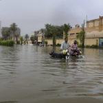 
              Motorcyclists navigate a flooded road after heavy rains, in Karachi, Pakistan, Monday, July 25, 2022. Pakistani officials say monsoon rains lashed Pakistan's largest city of Karachi and elsewhere, inundating several low-lying neighborhoods, flooding even the city's upscale areas and disrupting normal life. Since June 14, more than 300 people have been killed in rain-related incidents across Pakistan. (AP Photo/Fareed Khan)
            