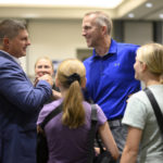 
              Republican Congressional candidate Brad Finstad, left, shakes hands with longtime friend, Steve Gilles, right, during an election night party for Finstad, Tuesday, Aug. 9, 2022, at the Sleepy Eye Event Center in Sleepy Eye, Minn. Finstad has won the special election to U.S. House in Minnesota's 1st Congressional District. (Aaron Lavinsky/Star Tribune via AP)
            