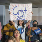 
              Charlie Crist supporter Sandy Moise holds sign as U.S. Rep. Charlie Crist announces his running mate Karla Hernández-Mats at Hialeah Middle School in Hialeah, Fla., Saturday Aug. 27, 2022 as he challenges Republican Gov. Ron DeSantis in November (AP Photo/Gaston De Cardenas)
            