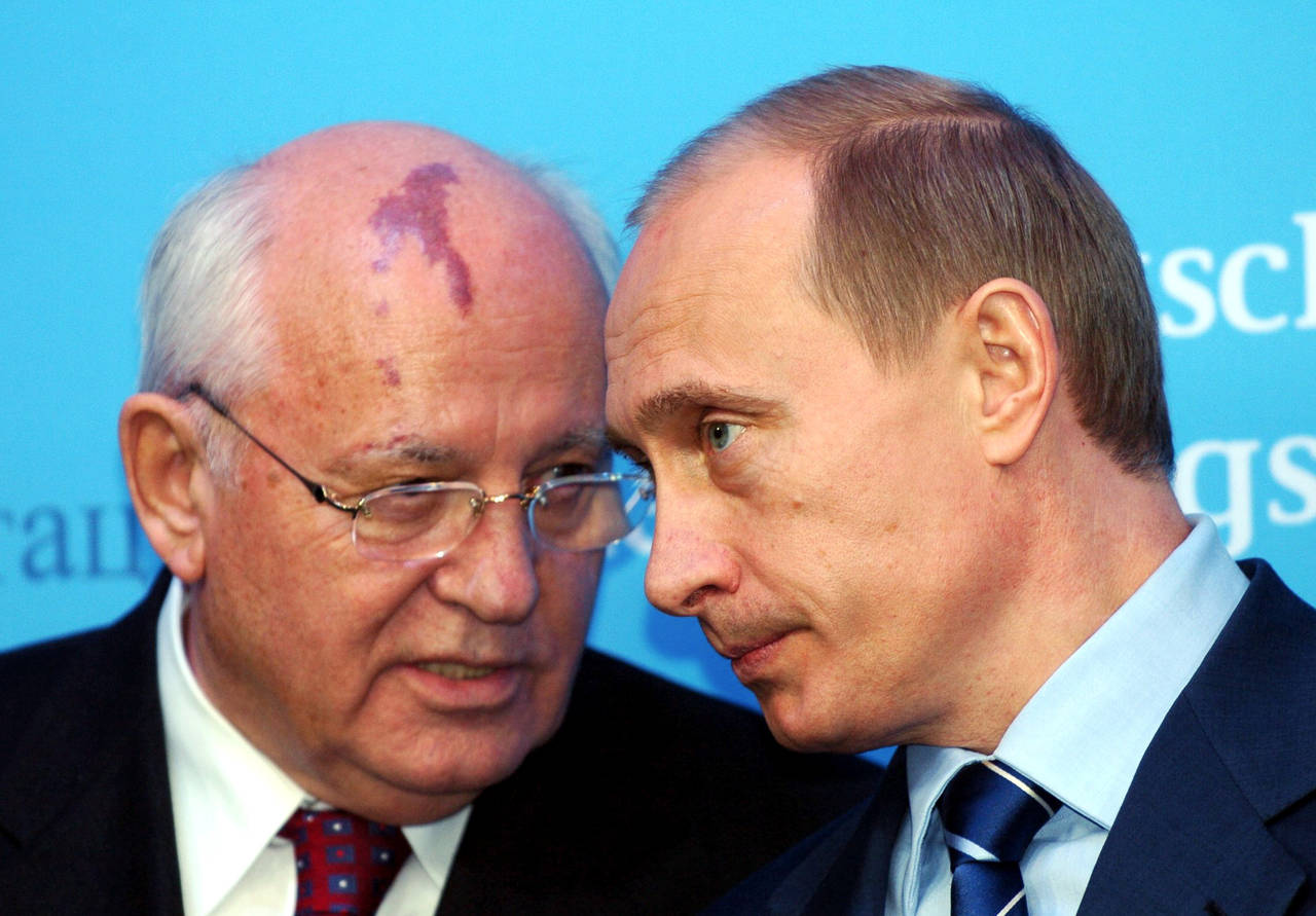 FILE - Russia's President Vladimir Putin, right, talks with former Soviet President Mikhail Gorbach...