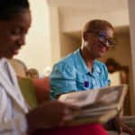 
              CORRECTS SPELLING FROM ONLEY TO OLNEY - Nikiesha Thomas' sister Keeda Simpson, left, and mother Nadine Thomas look through family photos at Nadine's home in Olney, Md., Thursday, Aug. 25, 2022. Nikiesha Thomas was shot and killed by her ex-boy boyfriend just days after filing for a protective order last October. Victims of abuse and their families saw a quiet breakthrough this summer when the passage of a bipartisan gun safety bill in Congress included a proposal that would make it more difficult for intimate partners of convicted domestic abusers to obtain firearms. (AP Photo/Carolyn Kaster)
            