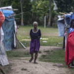 
              A resident walks through Camp Masse set up by people left homeless by last year’s 7.2-magnitude earthquake, in Les Cayes, Haiti, Wednesday, Aug. 17, 2022. Residents have complained that no government official had visited them despite repeated promises that they would come to help. (AP Photo/Odelyn Joseph)
            