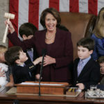 
              FILE - Newly elected Speaker of the House Nancy Pelosi, holds up the gavel surrounded by children and grandchildren of members of Congress in the U.S. Capitol in Washington, Jan. 4, 2007. (AP Photo/Pablo Martinez Monsivais, File)
            