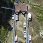 
              FILE - Boats lie on the dried riverbed at a tourist dock along the Po river in Sermide, Italy, Thursday, Aug. 11, 2022. The river Po runs 652 kilometers (405 miles) from the northwestern city of Turin to Venice. (AP Photo/Luigi Navarra, File)
            