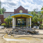 
              Debris and mud surround the entrance to Robinson Elementary School near Ary in Perry County, Ky., on Tuesday, Aug. 2, 2022. Floodwaters devastated many communities in Eastern Kentucky the week before. (Ryan C. Hermens/Lexington Herald-Leader via AP)
            