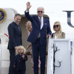 
              President Joe Biden, center, waves as he is joined by, from left, son Hunter Biden, grandson Beau Biden, first lady Jill Biden, and daughter-in-law Melissa Cohen, as they stand at the top of the steps of Air Force One at Andrews Air Force Base, Md., Wednesday, Aug. 10, 2022. They are heading to South Carolina for a week-long vacation on Kiawah Island. (AP Photo/Susan Walsh)
            