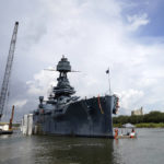 
              Work continues at the USS Texas in preparation for moving and repairs Tuesday, Aug. 30, 2022, in La Porte, Texas. The USS Texas, which was commissioned in 1914 and served in both World War I and World War II, is scheduled to be towed down the Houston Ship Channel Wednesday to a dry dock in Galveston where it will undergo an extensive $35 million repair. (AP Photo/David J. Phillip)
            