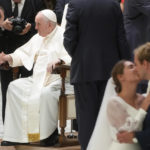 
              A newly married couple kisses during Pope Francis's weekly general audience in the Paul VI Hall at The Vatican, Wednesday, Aug. 24, 2022. (AP Photo/Gregorio Borgia)
            