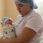 
              Alina Haupt, an intern-doctor, holds Veronika, a baby born prematurely at 29 weeks, at the Pokrovsk Perinatal Hospital in Pokrovsk, Donetsk region, eastern Ukraine, Monday, Aug. 15, 2022. Doctors say the stress caused by the war and rapidly worsening living conditions are leading to more frequent birth complications for the area's pregnant women. (AP Photo/David Goldman)
            