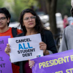 
              Rep. Rashida Tlaib, D-Mich., center, and her son Adam, left, attend a rally to urge President Joe Biden to cancel student debt near the White House in Washington, Wednesday, July 27, 2022. (AP Photo/Andrew Harnik)
            