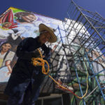 
              Mexican artist Janet Calderon prepares to work on a mural she is helping to paint in San Salvador, Mexico, Saturday, July 30, 2022. The mural in progress is on three walls of a municipal building in San Salvador, a small town of about 29,000 people north of Mexico City in Hidalgo state. (AP Photo/Fernando Llano)
            