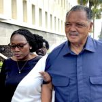 
              Rev. Jesse Jackson escorts Wanda Cooper Jones, Ahmaud Arbery's mother, into the federal courthouse, Monday, Aug. 8, 2022, in Brunswick, Ga., for the sentencing hearings of the 3 white men convicted of federal hate crimes in the killing of Arbery. (AP Photo/Lewis M. Levine)
            