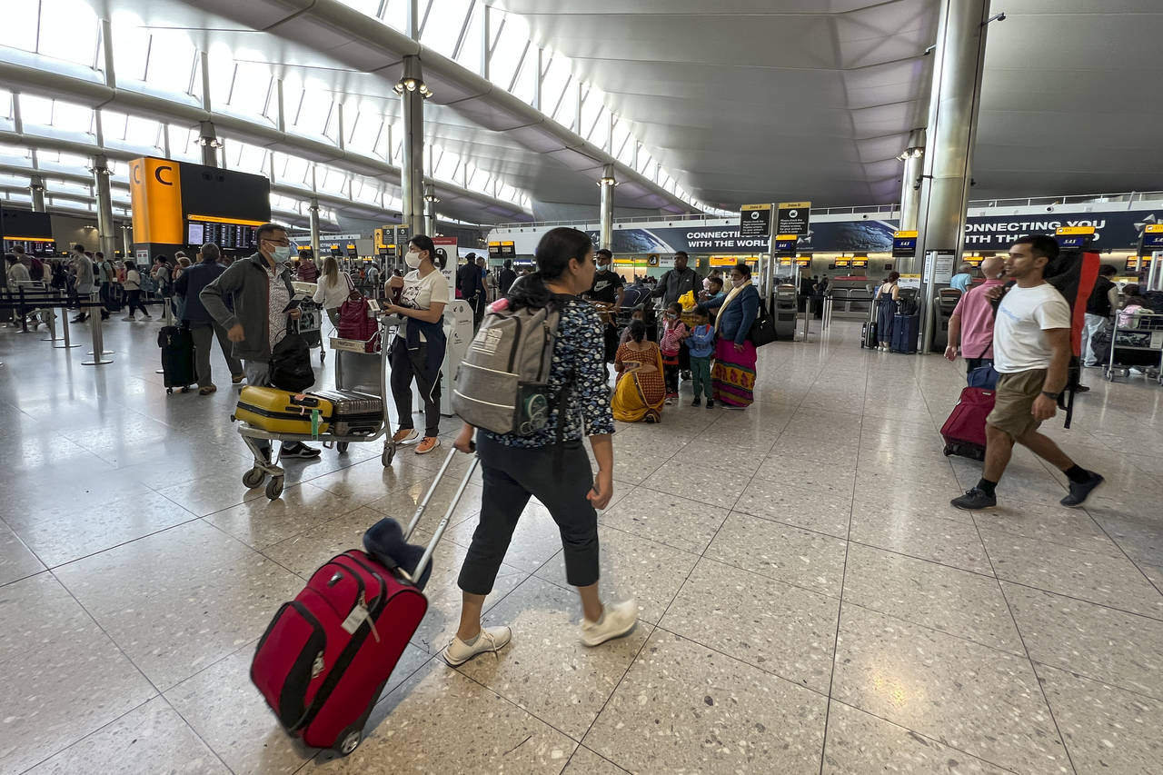 FILE - Travelers at Heathrow Airport in London, Wednesday, July 13, 2022. Heathrow Airport said Thu...