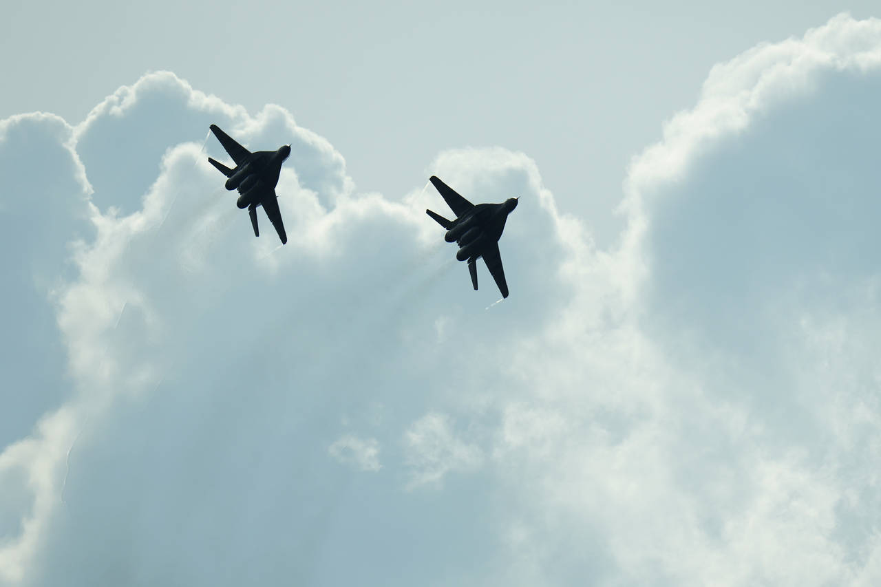Slovak Air Force MiG-29s fly over an airport during an airshow in Malacky, Slovakia, Saturday, Aug....