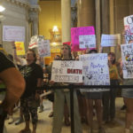 
              Abortion-rights protesters fill Indiana Statehouse corridors and cheer outside legislative chambers, Friday, Aug. 5, 2022, as lawmakers vote to concur on a near-total abortion ban, in Indianapolis. (AP Photo/Arleigh Rodgers)
            