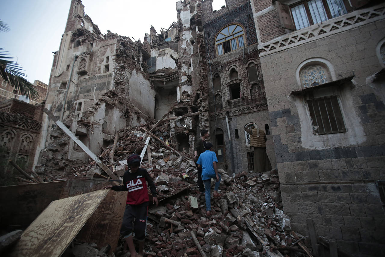 Yemeni people inspect a rains-collapsed UNESCO-listed building in the old city of Sanaa, Yemen, Wed...