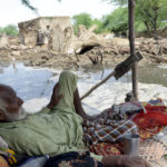 
              A man rests near his damaged home surrounded by floodwaters, in Jaffarabad, a district of Pakistan's southwestern Baluchistan province, Sunday, Aug. 28, 2022. Army troops are being deployed in Pakistan's flood affected area for urgent rescue and relief work as flash floods triggered after heavy monsoon rains across most part of the country lashed many districts in all four provinces. (AP Photo/Zahid Hussain)
            
