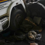 
              A skinny dog named Propaganda sleeps by a truck that used to move Colombian coal across the border to Venezuela, parked on the property of veteran businessman Alfredo Rosales in San Juan de Colon, Venezuela, Thursday, Aug. 4, 2022. Rosales said he had a prosperous fleet of over 50 trucks before the border was partially closed by the Venezuelan government in 2015, but had to downsize to four trucks and sell the rest as scrap as the coal import business dropped. (AP Photo/Matias Delacroix)
            