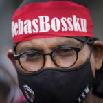 
              Supporters of former Malaysian Prime Minister Najib Razak, wearing a face mask and headband waiting outside at Court of Appeal in Putrajaya, Malaysia, Tuesday, Aug. 23, 2022. Najib was sentenced to 12 years in jail by a high court in July 2020, after being found guilty of abuse of power, criminal breach of trust and money laundering for illegally receiving 42 million ringgit ($9.4 million) from SRC International, a former unit of 1MDB. (AP Photo/Vincent Thian)
            