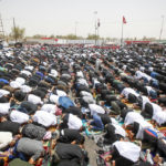 
              Supporters of the Shiite cleric Muqtada al-Sadr hold prayer near the parliament building in Baghdad, Iraq, Friday, Aug. 12, 2022. Al-Sadr's supporters continue their sit-in outside the parliament to demand early elections. (AP Photo/Anmar Khalil)
            