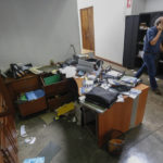 
              FILE - Confidencial director Carlos Fernando Chamorro, son of former President Violeta Barrios de Chamorro, walks through his ransacked offices while talking on his cellphone in Managua, Nicaragua, Dec. 14, 2018. In 2018 the government raided the headquarters of the newspaper Confidencial, led by journalist Carlos Fernando Chamorro, who is considered one of the most prominent critics of Ortega. (AP Photo/Alfredo Zuniga, File)
            