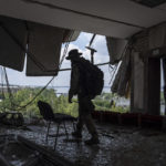 
              A Ukrainian serviceman walks inside of the headquarters of the Mykolaiv Regional Military Administration building destroyed by a Russian attack in Mykolaiv, Ukraine, Friday, Aug. 5, 2022. (AP Photo/Evgeniy Maloletka)
            