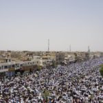 
              FILE - Followers of Shiite cleric Muqtada al-Sadr chant slogans during an open-air Friday prayers in Sadr City, Baghdad, Iraq,  July 15, 2022. Residents of the impoverished Baghdad suburb of Sadr City say they they support al-Sadr, an influential cleric who called on thousands of his followers to storm Iraq's parliament. Al-Sadr derives his political weight largely from their seemingly unending support. And yet, they are among Iraq’s most destitute. (AP Photo/Hadi Mizban, File)
            