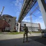 
              FILE - A Russian serviceman guards an area of the Zaporizhzhia Nuclear Power Station in territory under Russian military control, southeastern Ukraine, May 1, 2022. Moscow and Kyiv have traded accusations of shelling the Russia-occupied Zaporizhzhia nuclear power plant, Europe's largest, that fueled fears of a nuclear disaster. (AP Photo, File)
            