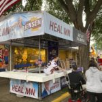 
              Campaign workers set up the booth for Republican gubernatorial candidate Scott Jensen on the opening day of the Minnesota State Fair on Thursday, Aug. 25, 2022, in Falcon Heights, Minn. (AP Photo/Steve Karnowski)
            