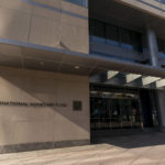 
              FILE - A pedestrian walks past the International Monetary Fund building, April 5, 2021, in Washington. The IMF is facing pressure to eliminate, or at least, reevaluate how it imposes fees on loans it disperses to needy countries like war-torn Ukraine — which is one of the fund's biggest borrowers. (AP Photo/Andrew Harnik, File)
            