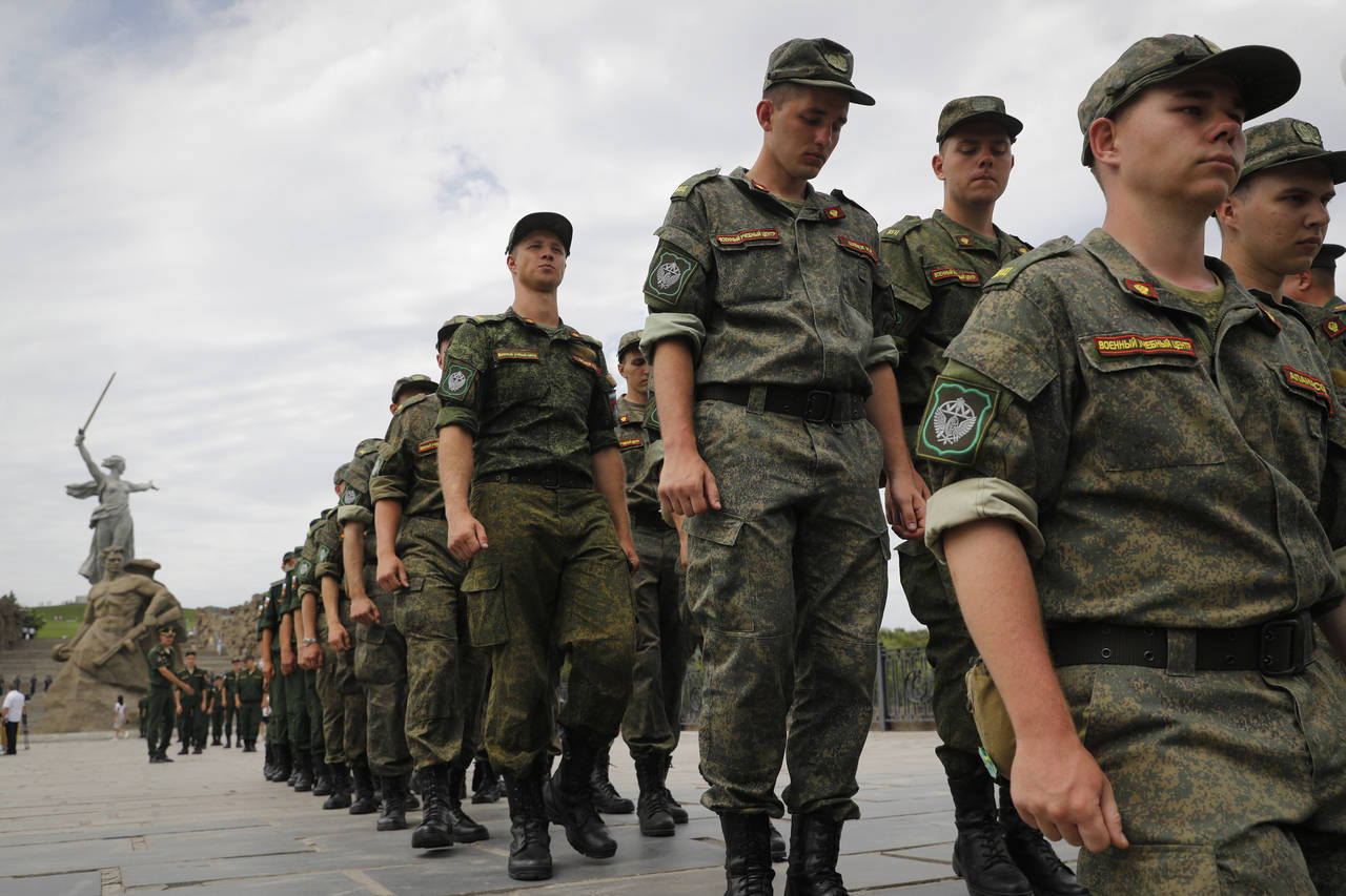 FILE - Russian army soldiers march during an action in support for the soldiers involved in the mil...