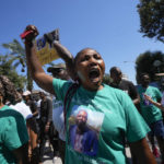 
              A woman wears a t-shirt with the picture of Nigerian street vendor Alika Ogorchukwu and a writing reading: We all have the right to be alive, during a protest in Civitanova Marche, Italy, Saturday, Aug. 6, 2022. The brutal killing of Ogorchukwu in broad daylight has sparked a debate in this well-to-do Adriatic beach community over whether the attack by an Italian man with a court-documented history of mental illness was racially motivated. (AP Photo/Antonio Calanni)
            
