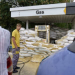 
              Deteriorating sandbags fortify a gas pump as customers wait in line in Kostiantynivka, Donetsk region, eastern Ukraine, Saturday, Aug. 20, 2022. (AP Photo/David Goldman)
            