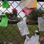 
              Messages are pinned to a fence at a make-shift memorial to honor the victims of the shootings at Robb Elementary School, Thursday, Aug. 25, 2022, in Uvalde, Texas. The community is preparing for classes to resume in the coming weeks. (AP Photo/Eric Gay)
            