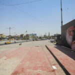 
              A poster depicting Muqtada al-Sadr, right, and his father, Mohammed Sadiq al-Sadr are displayed in Sadr City, Baghdad, Iraq, Thursday, Aug. 4, 2022.  Residents of the impoverished Baghdad suburb of Sadr City say they they support an influential Shiite cleric who called on thousands of his followers to storm Iraq's parliament.   (AP Photo/Anmar Khalil)
            