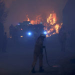 
              Firefighters battle a wildfire in Gouveia, in the Serra da Estrela mountain range, in Portugal on Thursday, Aug. 18, 2022. Authorities in Portugal said Thursday they had brought under control a wildfire that for almost two weeks raced through pine forests in the Serra da Estrela national park, but later in the day a new fire started and threatened Gouveia. (AP Photo/Joao Henriques)
            