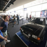 
              People view the Ford Escort RS Turbo Series 1, previously owned by Diana, Princess of Wales, on display at the Silverstone Race Circuit near Towcester, Northamptonshire, England, before it goes under the hammer on Saturday at Silverstone Classics, Saturday Aug. 27, 2022. (Joe Giddens/PA via AP)
            