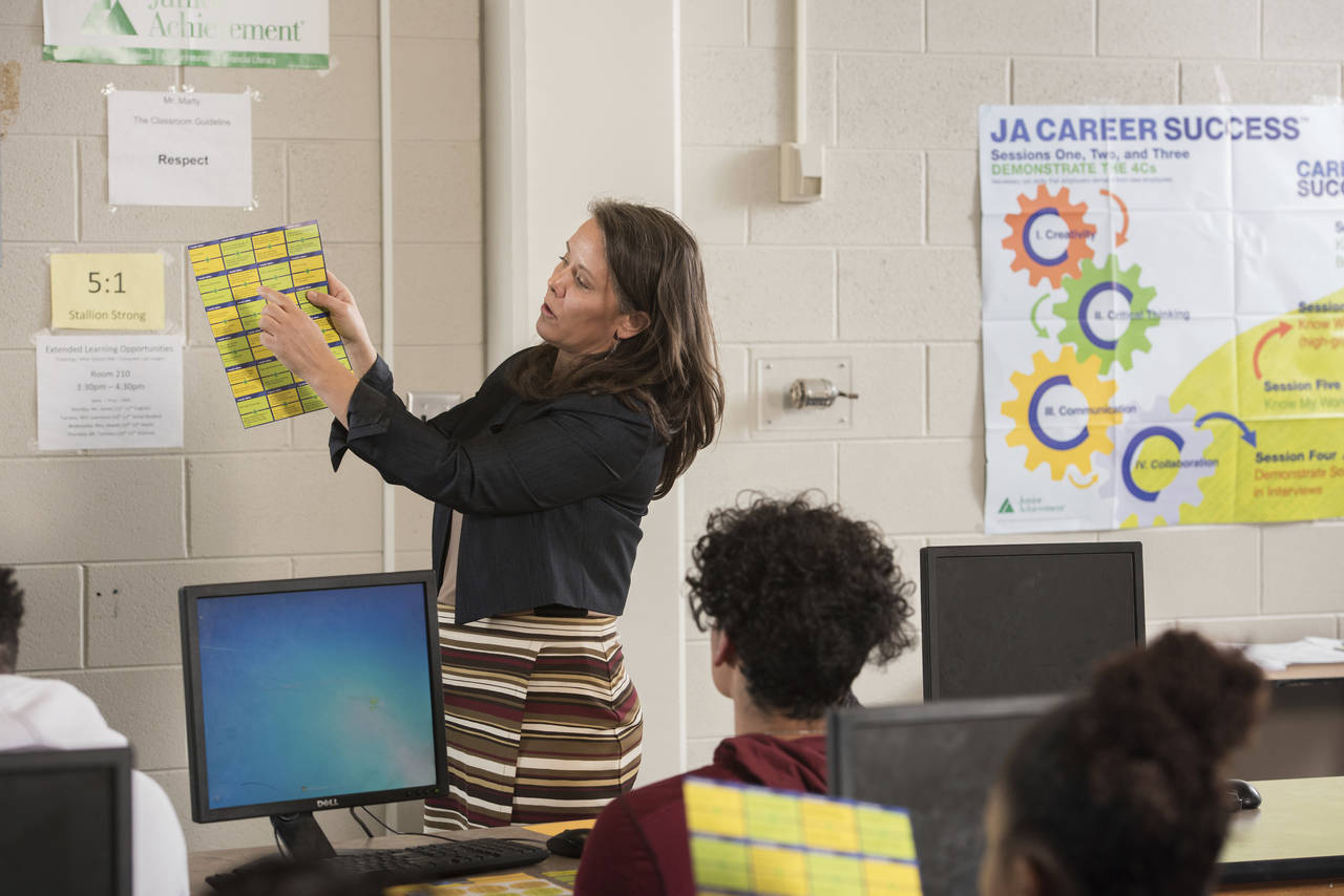 In this photo provided by Junior Achievement USA, volunteer Cammy Elquist LoRé teaches a Colorado ...