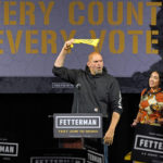 
              Pennsylvania Lt. Gov. John Fetterman, the Democratic nominee for the state's U.S. Senate seat, waves a towel after being introduced by wife Gisele Barreto Fetterman, right, during a rally in Erie, Pa., on Friday, Aug. 12, 2022. (AP Photo/Gene J. Puskar)
            