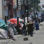 
              FILE - In this May 30, 2019 file photo, tents housing homeless line a street in downtown Los Angeles.The Los Angeles City Council has voted to ban homeless encampments within 500 feet of schools and daycare centers. The council voted Tuesday, Aug. 9, 2022, to broaden an existing ban on sleeping or camping near the facilities. (AP Photo/Richard Vogel, File)
            