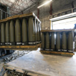 
              FILE - U.S. Air Force Staff Sgt. Cody Brown, right, with the 436th Aerial Port Squadron, checks pallets of 155 mm shells ultimately bound for Ukraine, April 29, 2022, at Dover Air Force Base, Del. The Biden administration has announced another $1 billion in new military aid for Ukraine. The Aug. 8 pledge promises what will be the biggest yet delivery of rockets, ammunition and other arms straight from Department of Defense stocks for Ukrainian forces. (AP Photo/Alex Brandon, File)
            