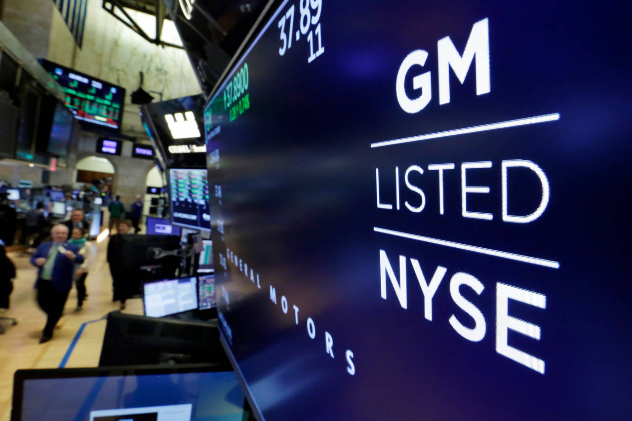 FILE - The logo for General Motors appears above a trading post on the floor of the New York Stock ...