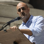 
              British novelist Hari Kunzru reads part of "The Satanic Verses" during a reading event in solidarity of support for author Salman Rushdie outside the New York Public Library, Friday, Aug. 19, 2022, in New York. (AP Photo/Yuki Iwamura)
            