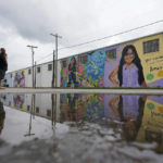 
              A couple visits murals created to honor the victims of the shootings at Robb Elementary School, Thursday, Aug. 25, 2022, in Uvalde, Texas. The community is preparing for classes to resume in the coming weeks. (AP Photo/Eric Gay)
            