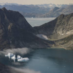 
              FILE - Icebergs are seen through a window of an airplane carrying NASA scientists as they fly on a mission to track melting ice in eastern Greenland on Aug. 14, 2019. Zombie ice from the massive Greenland ice sheet will eventually raise global sea level by at least 10 inches (27 centimeters) on its own, according to a study released Monday, Aug. 29, 2022.  Zombie or doomed ice is still attached to thicker areas of ice, but it’s no longer getting fed by those larger glaciers. (AP Photo/Mstyslav Chernov, File)
            